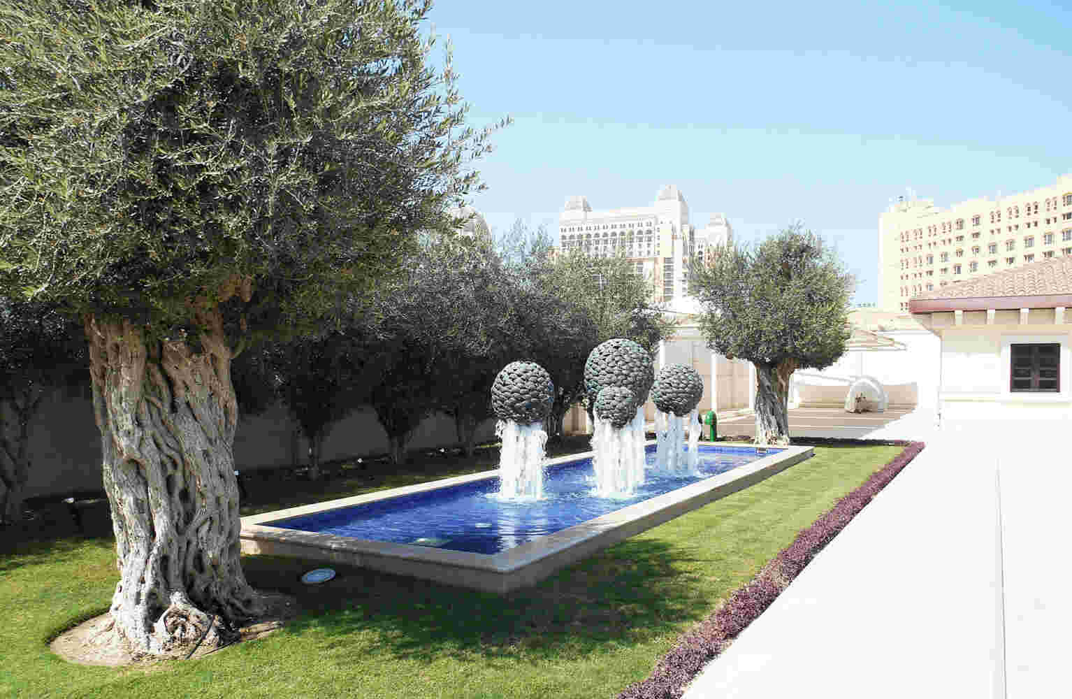 Fishball fountain made of cast bronze fish spheres, with water running through it