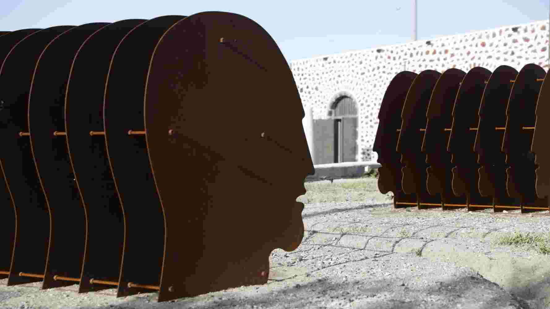 Face Large face sculpture with multiple layers of rusted steel