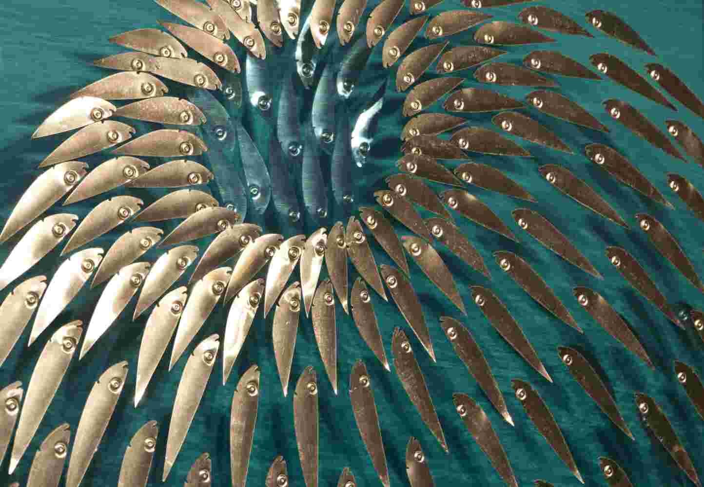 Three-dimensional wall sculpture, school of fish theme, with layers of plexiglass, aluminum frame and spherical aluminum fish.