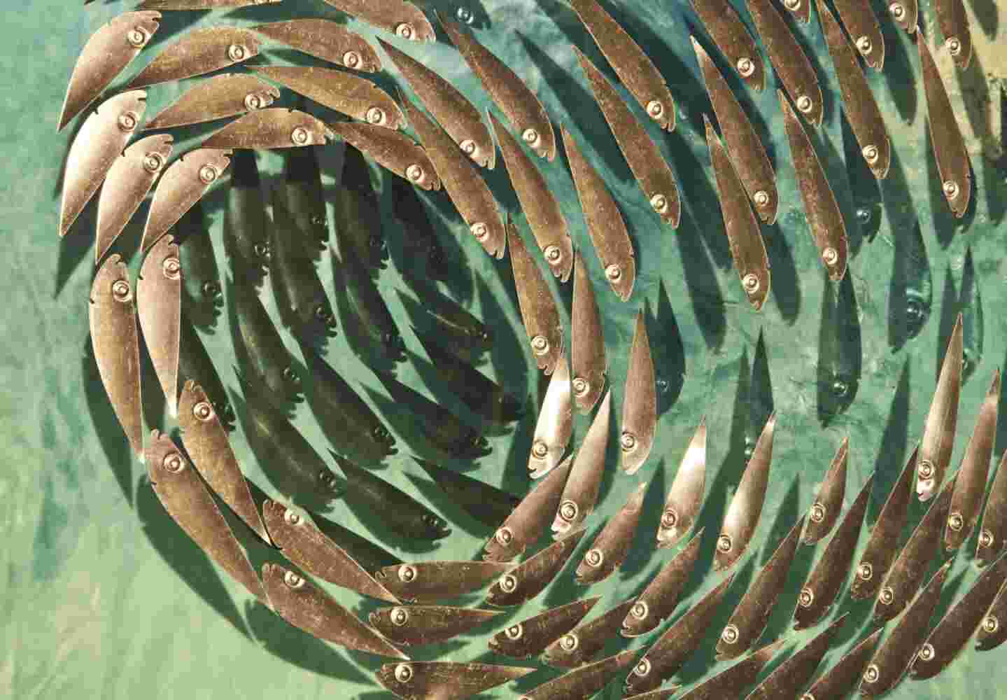 Three-dimensional wall sculpture, school of fish theme, with layers of plexiglass, aluminum frame and spherical aluminum and copper fish.