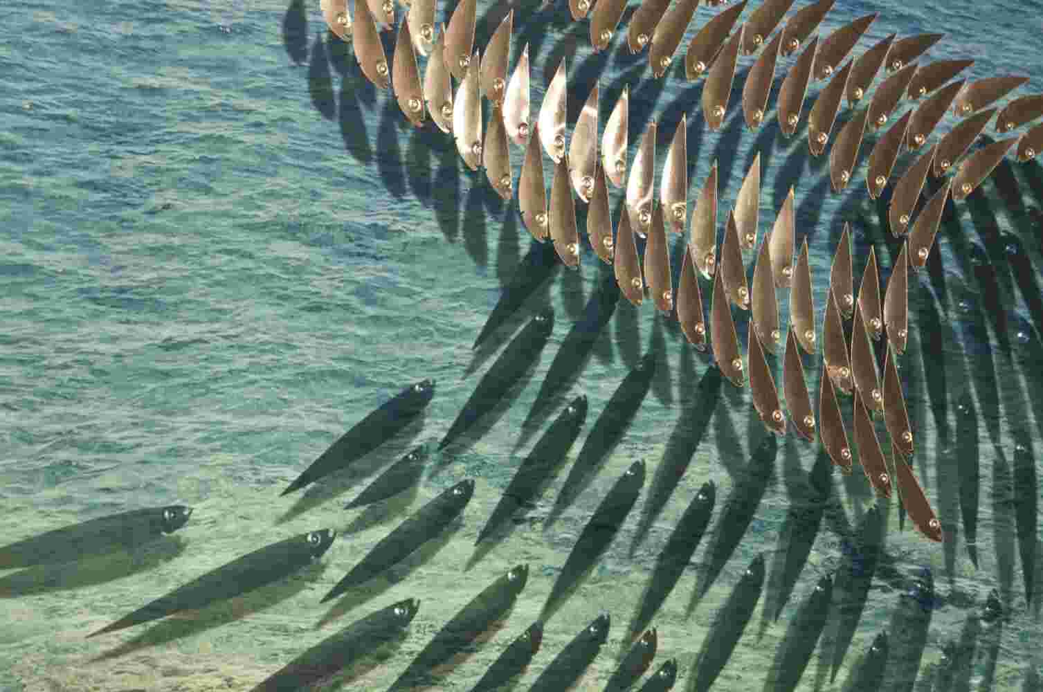 Three-dimensional wall sculpture, school of fish theme, with layers of plexiglass, aluminum frame and a wave of aluminum and copper fish.