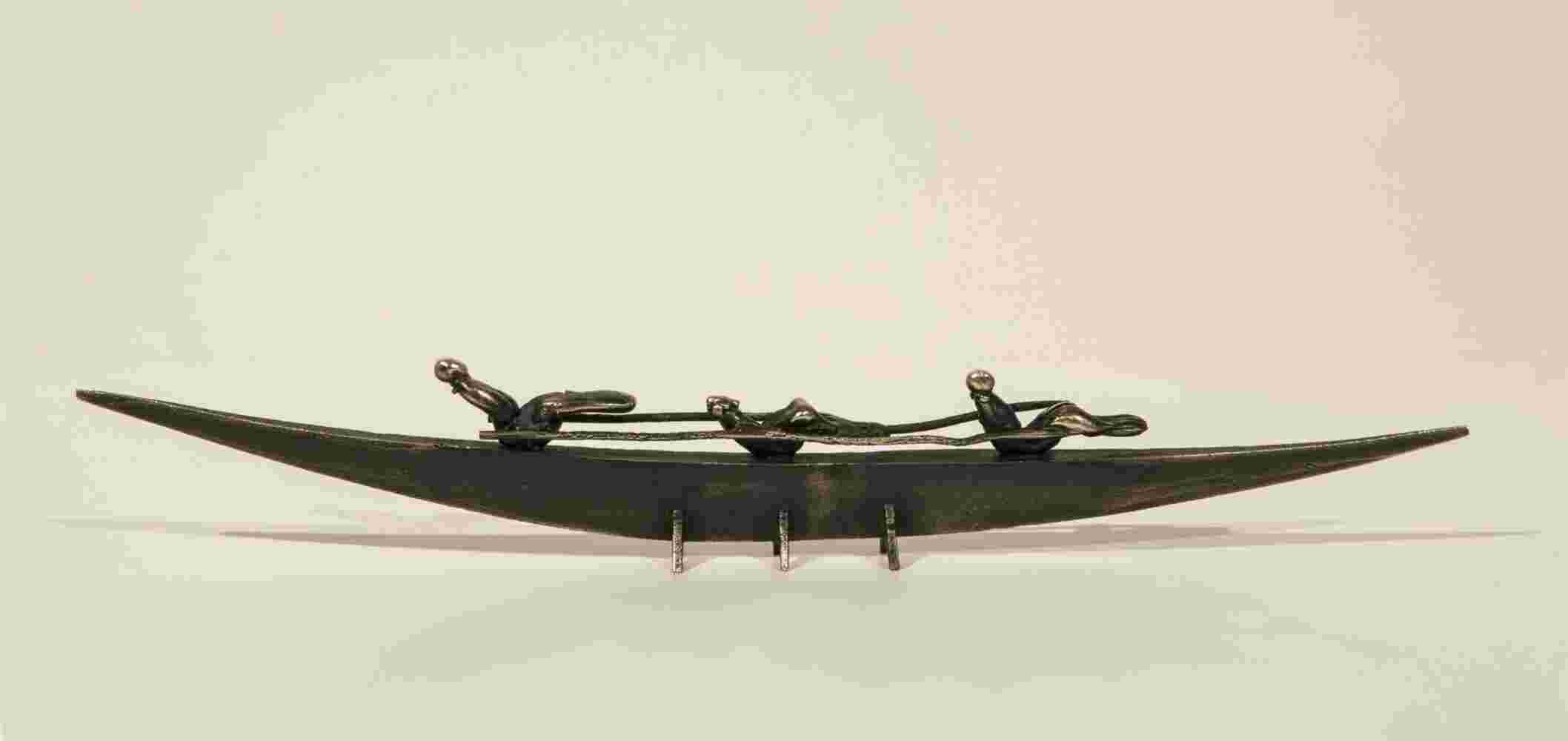 Small boat sculpture made of cast bronze.