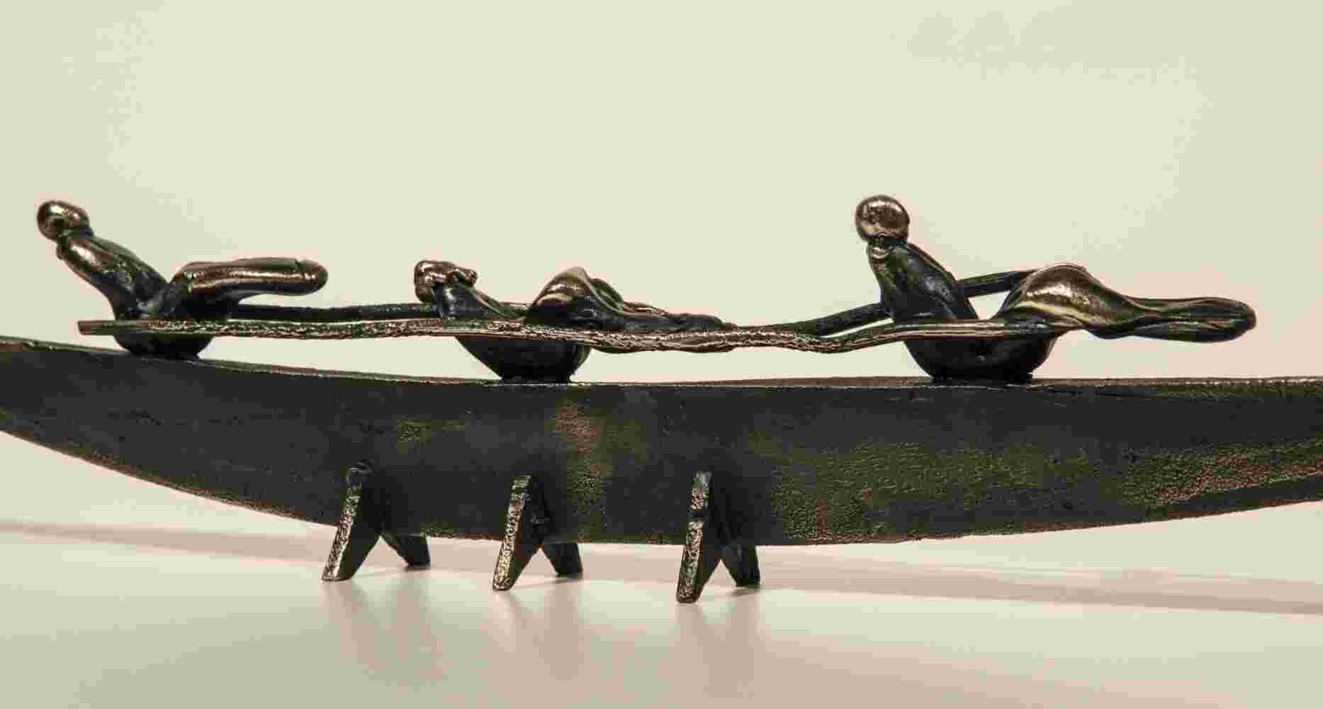 Small boat sculpture made of cast bronze.