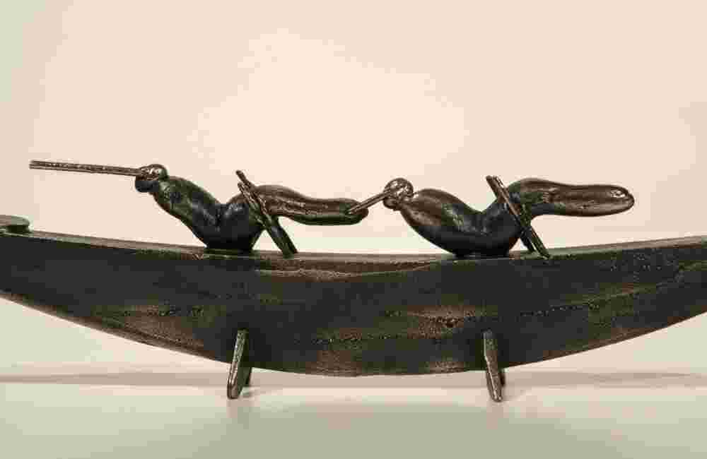 Small boat sculpture made of cast bronze.