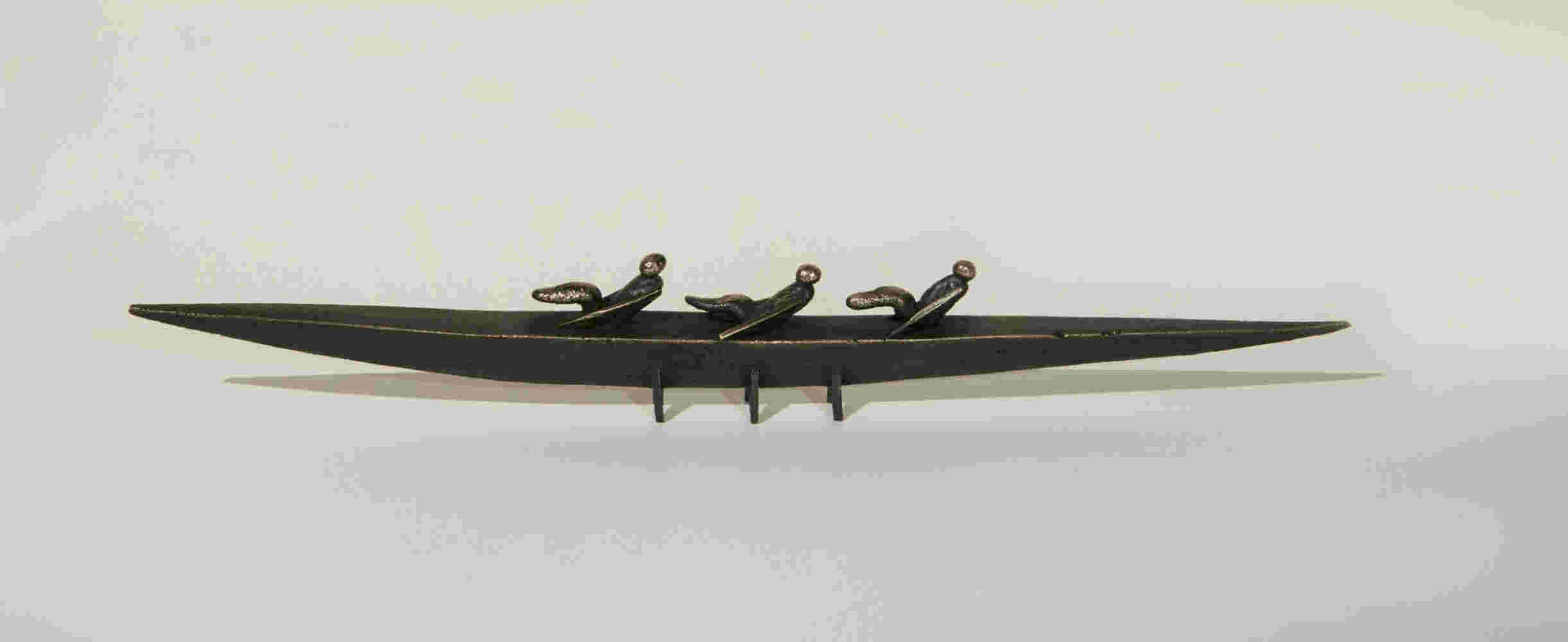 Small boat sculpture made of cast bronze.