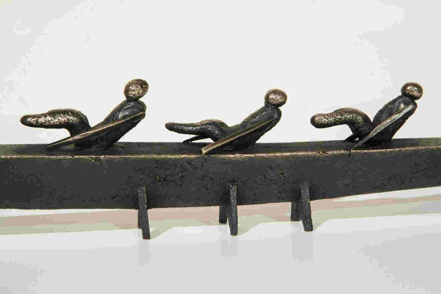 Small boat sculpture made of cast bronze.