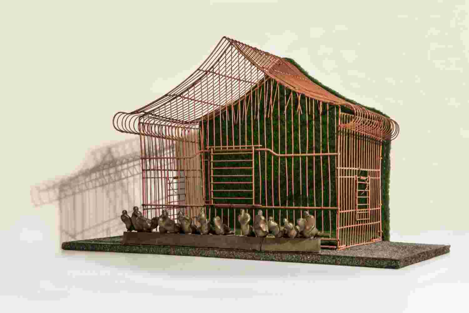 Mixed media wall sculpture of a cage with little people made of bronze