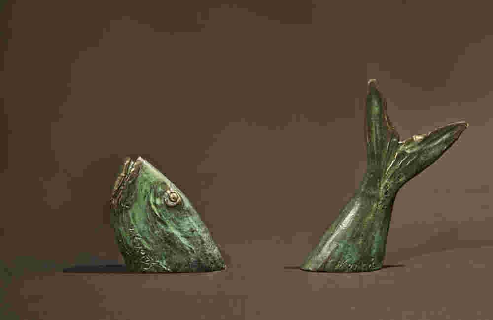 Fish small green bronze sculpture going in and out of the water