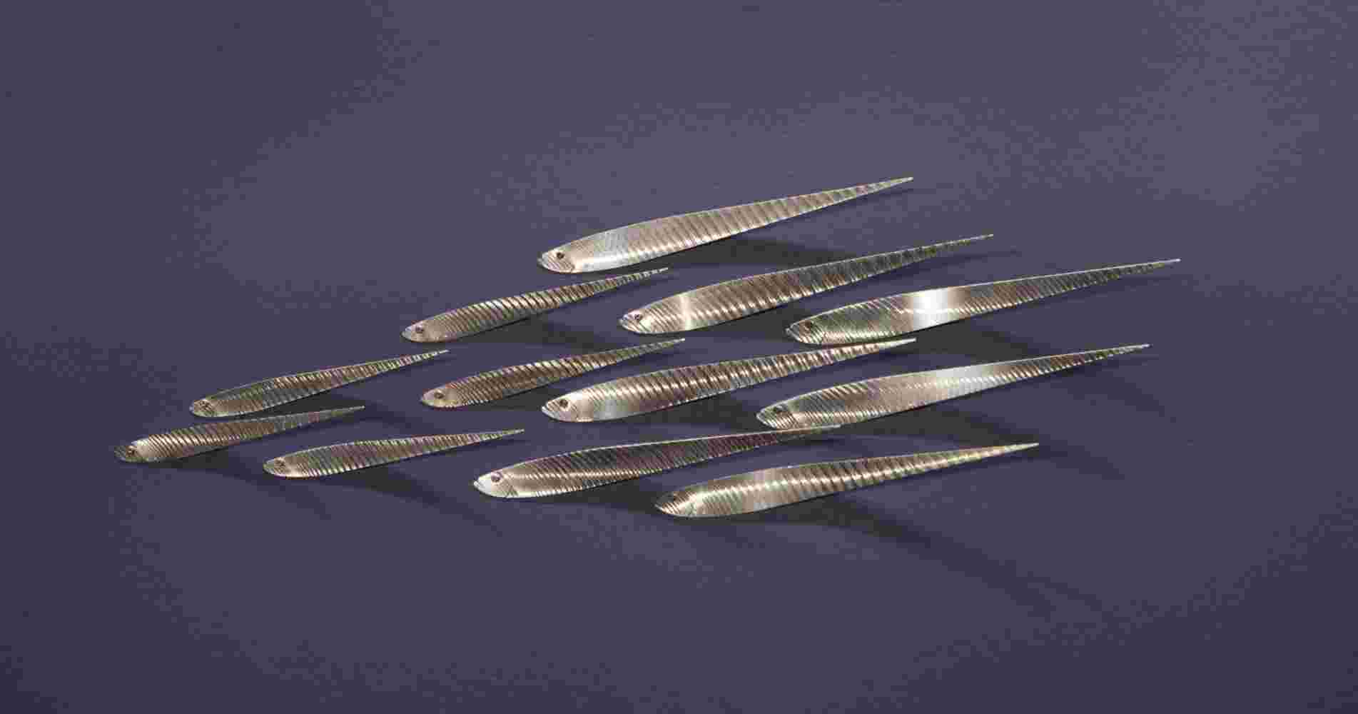 Wall installation of flowing stainless steel school of fish