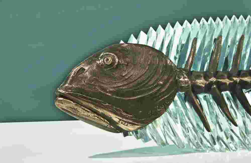 Glass and bronze sculpture of a fish.