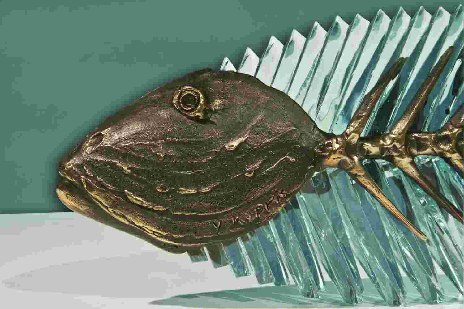 Glass and bronze sculpture of a fish.