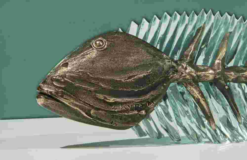 Hand cut glass and bronze sculpture of a fish.