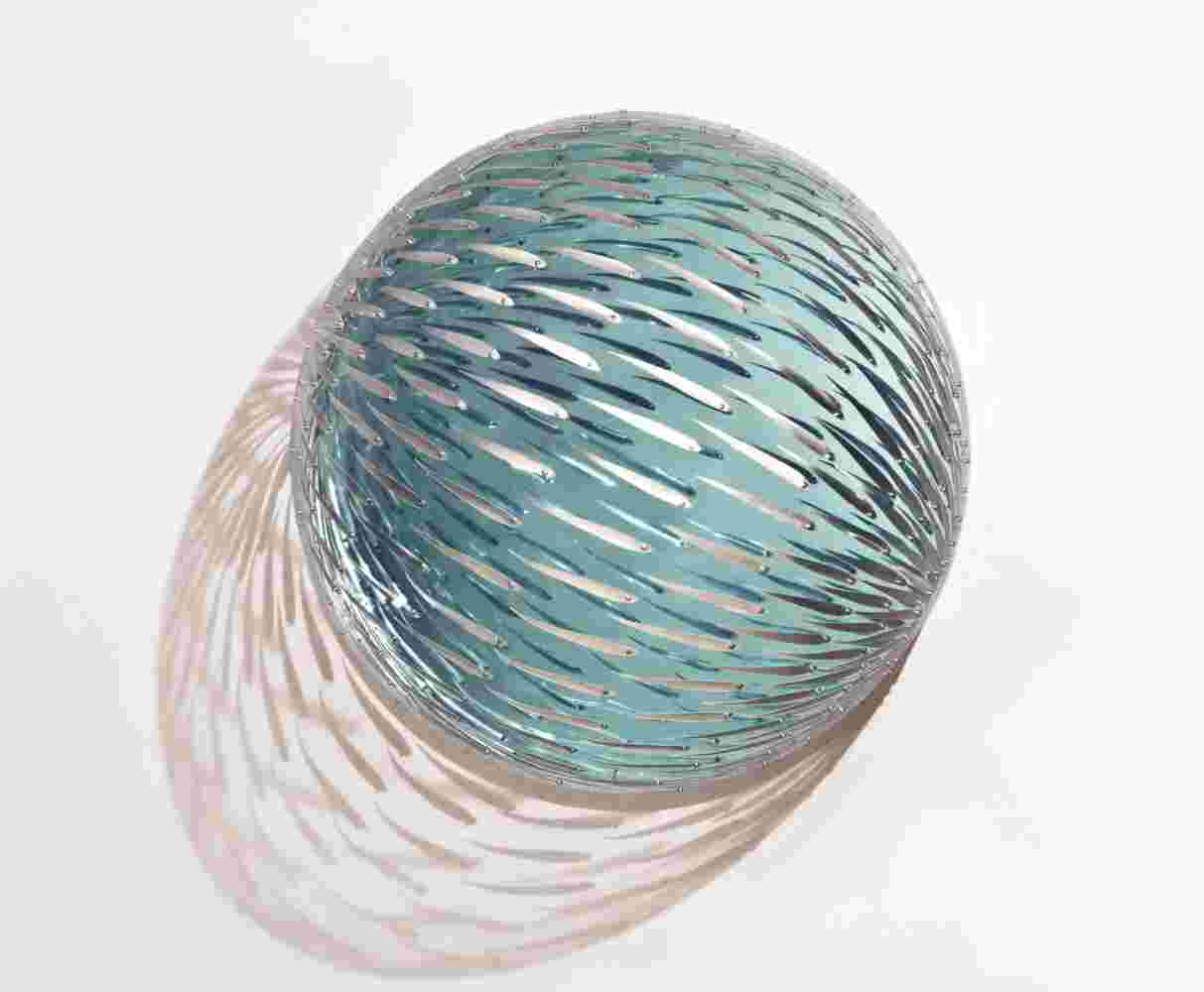 Acrylic hemisphere with metallic fish create a swirling effect that resembles underwater shoals