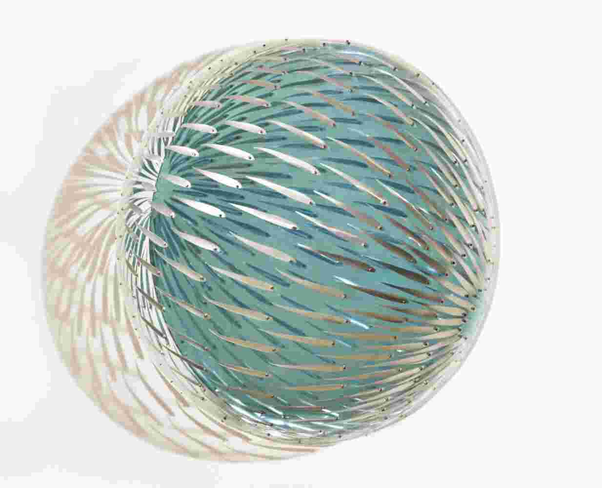 Acrylic hemisphere with metallic fish create a swirling effect that resembles underwater shoals