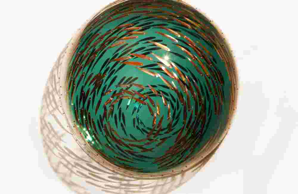 Acrylic hemisphere with metallic copper fish create a swirling effect that resembles underwater shoals
