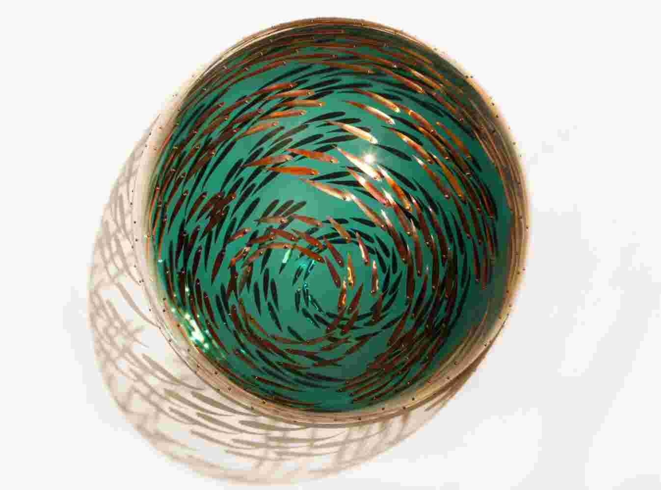 Acrylic hemisphere with metallic copper fish create a swirling effect that resembles underwater shoals