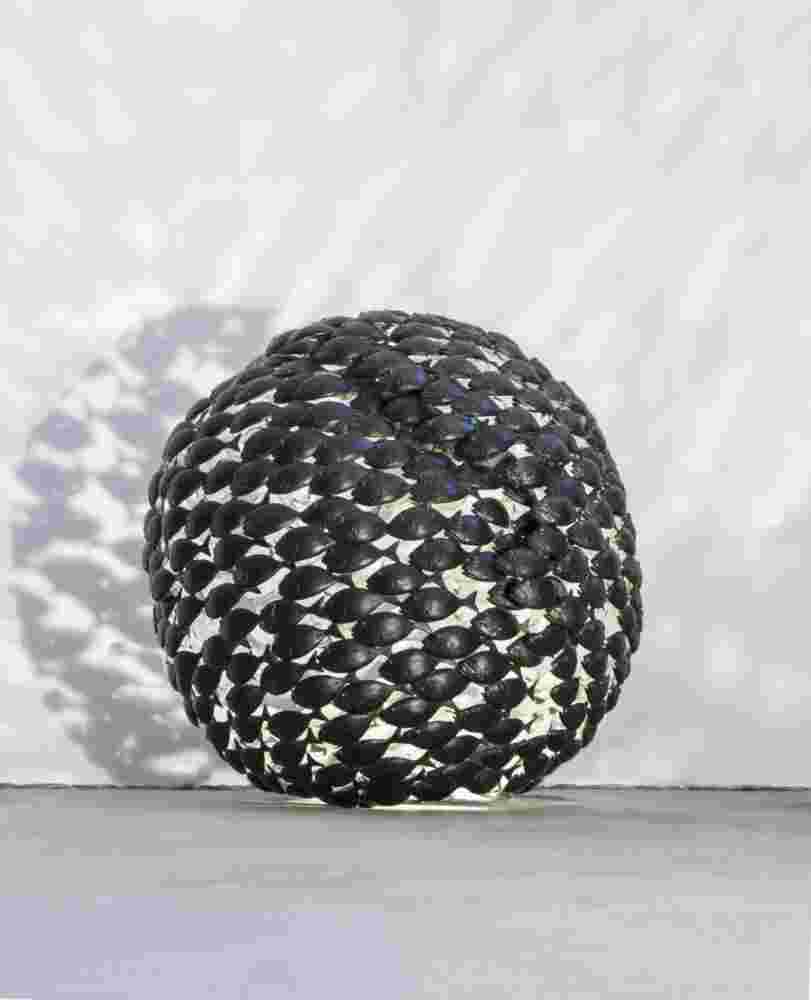 Sphere of a school of fish made of cast bronze with a green patina inside.