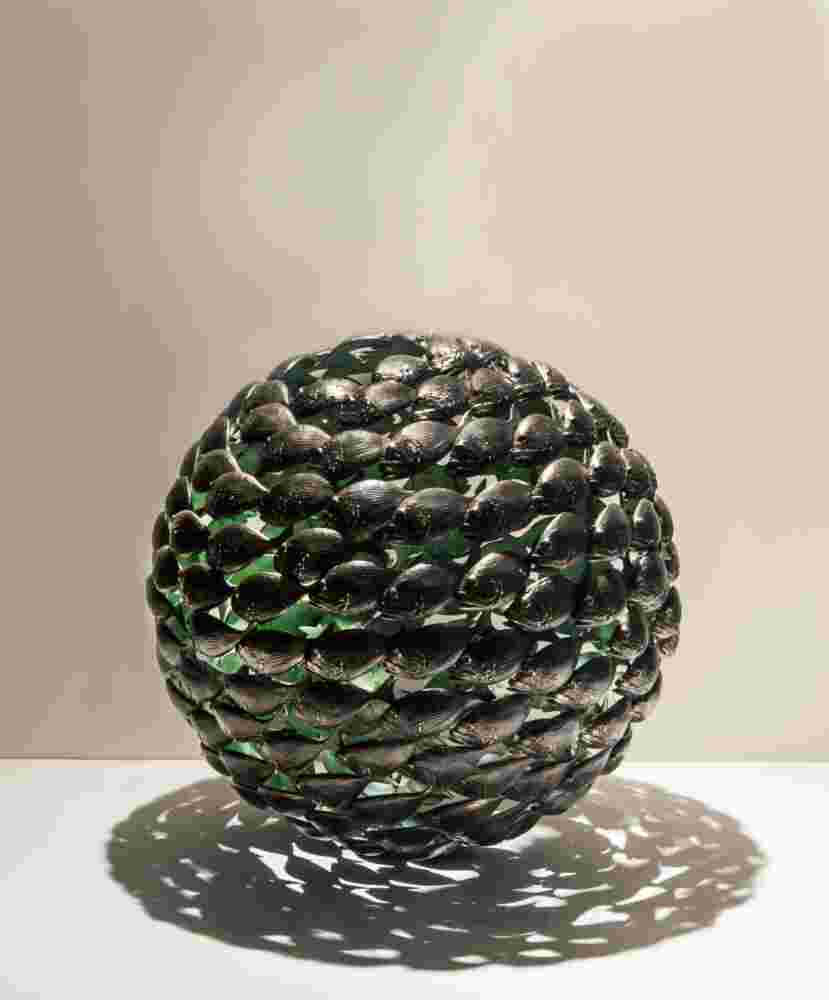 Bronze fish shoal ball with a green interior made of cast bronze