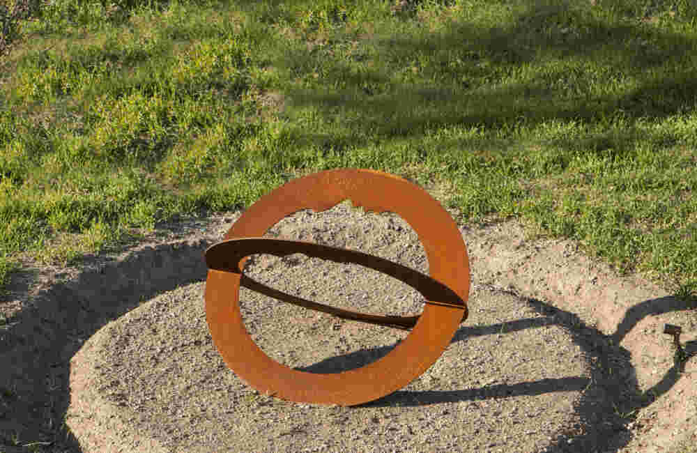 Rusted steel spiral sculpture with the shape of a head