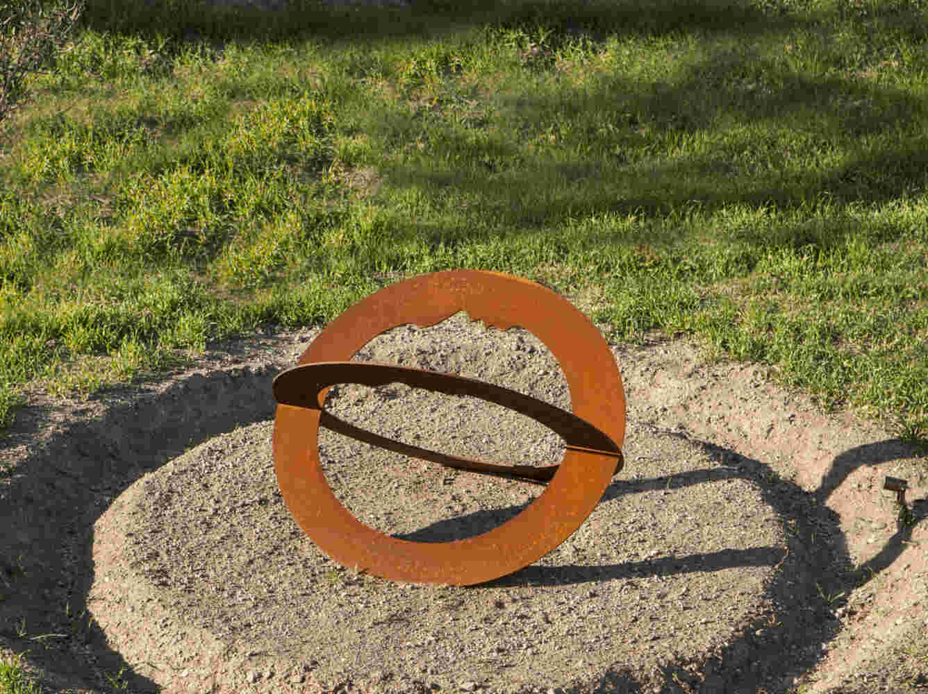 Rusted steel spiral sculpture with the shape of a head