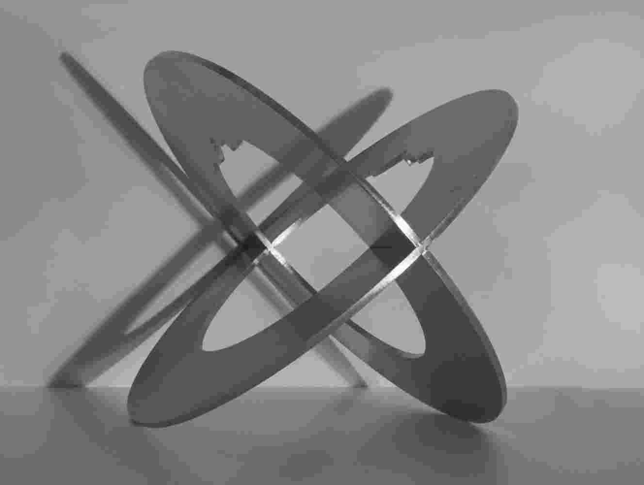 Spherical staineless steel sculpture with a cut out of a head