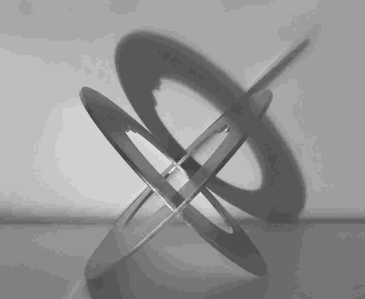 Spherical staineless steel sculpture with a cut out of a head