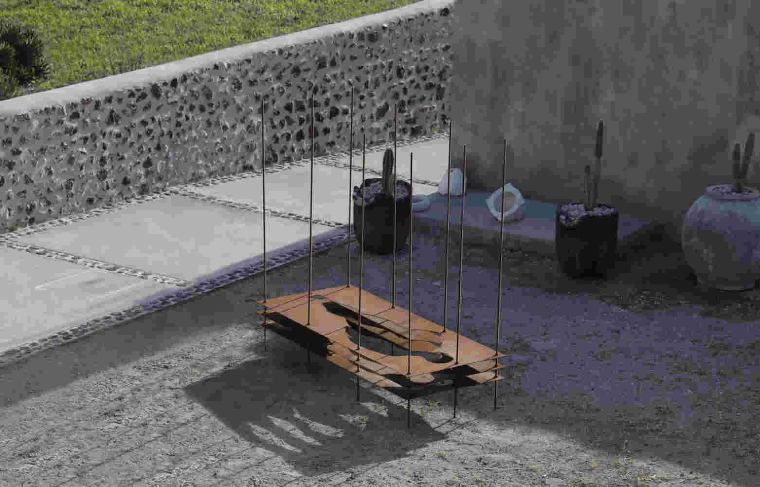 Sculpture made of multiple layers of rusted steel with the shape of a human cut in the middle