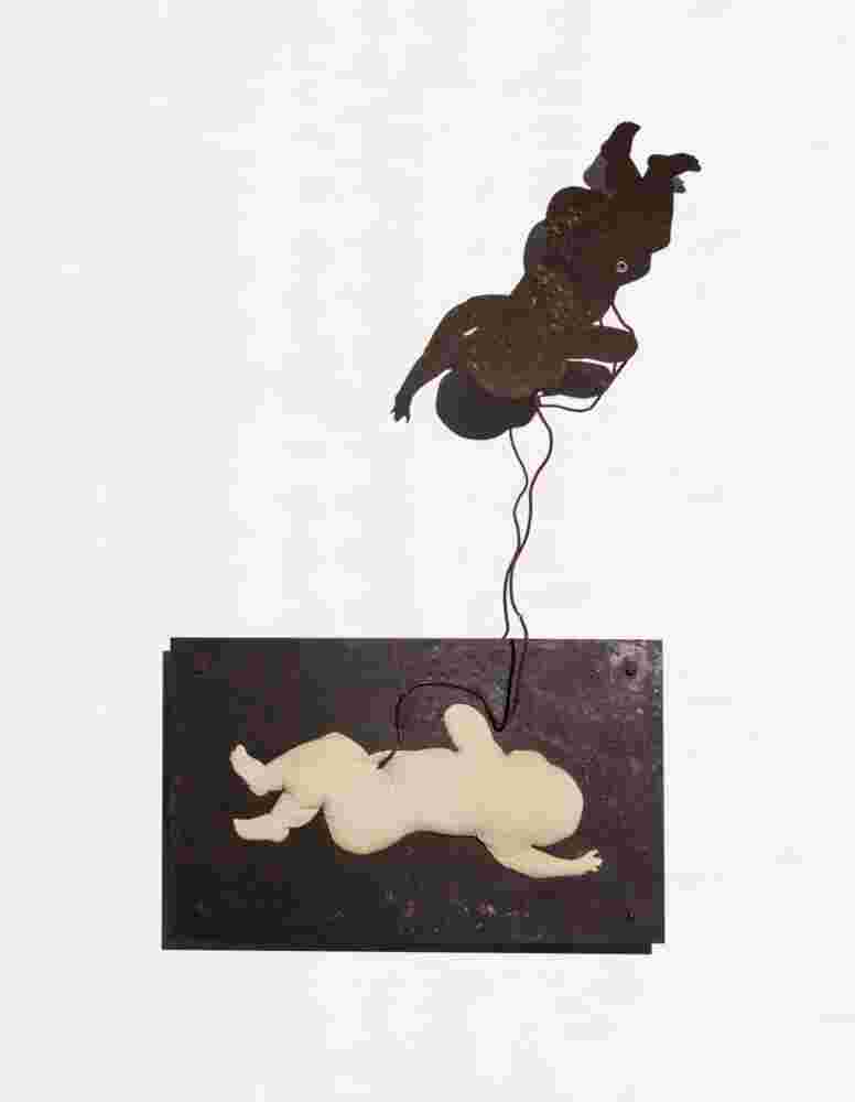 Wall sculpture made of iron and a pillow of a baby flying