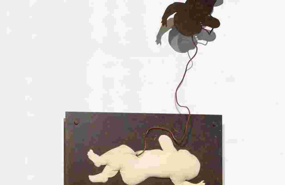 Wall sculpture made of iron and a pillow of a baby flying