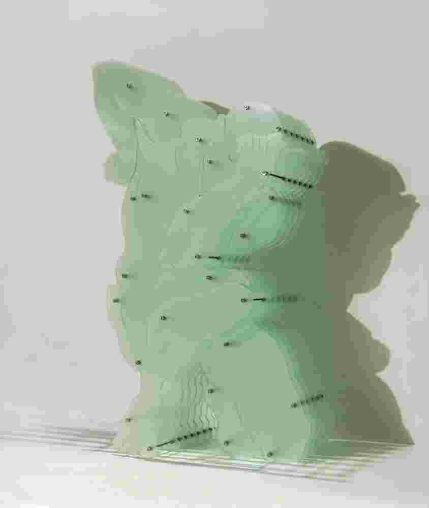 Plexiglass sculpture of a man with multi layers of plexiglass. Thinkers pose.