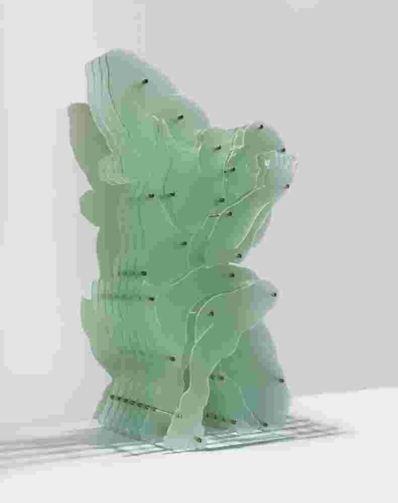 Plexiglass sculpture of a man with multi layers of plexiglass. Thinkers pose.