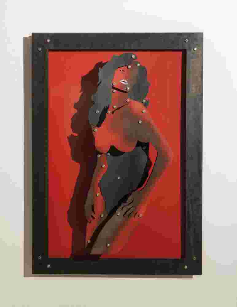 Red wall installation of a woman made of multi layers of black and colored steel.