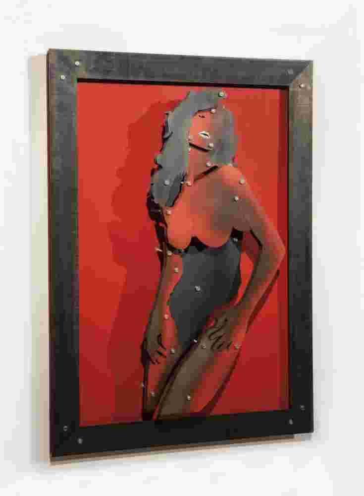 Red wall installation of a woman made of multi layers of black and colored steel.