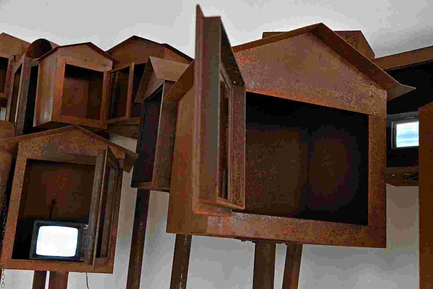 Large art installation of 29 shrines made of rusted steel