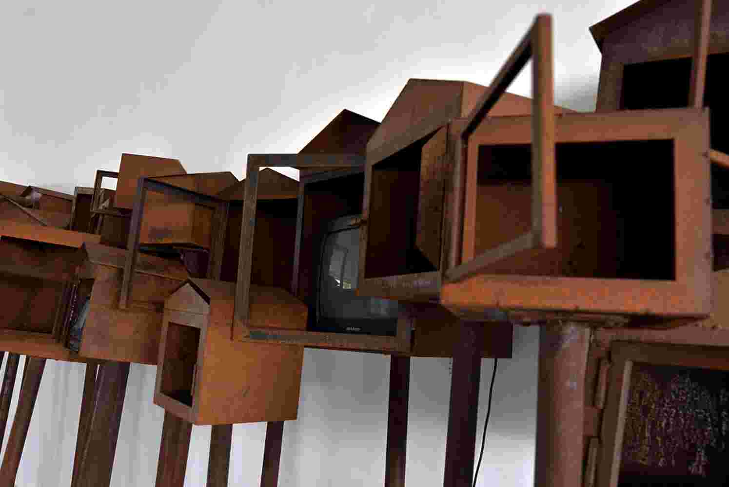Large art installation of 29 shrines made of rusted steel