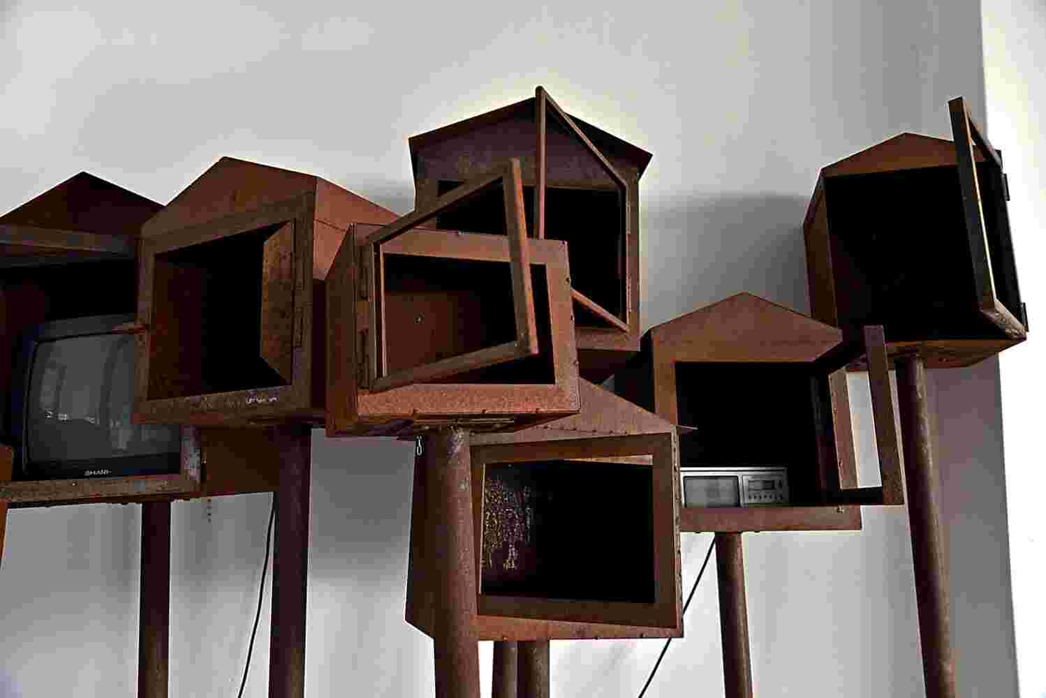 Large art installation of 29 shrines made of rusted steel