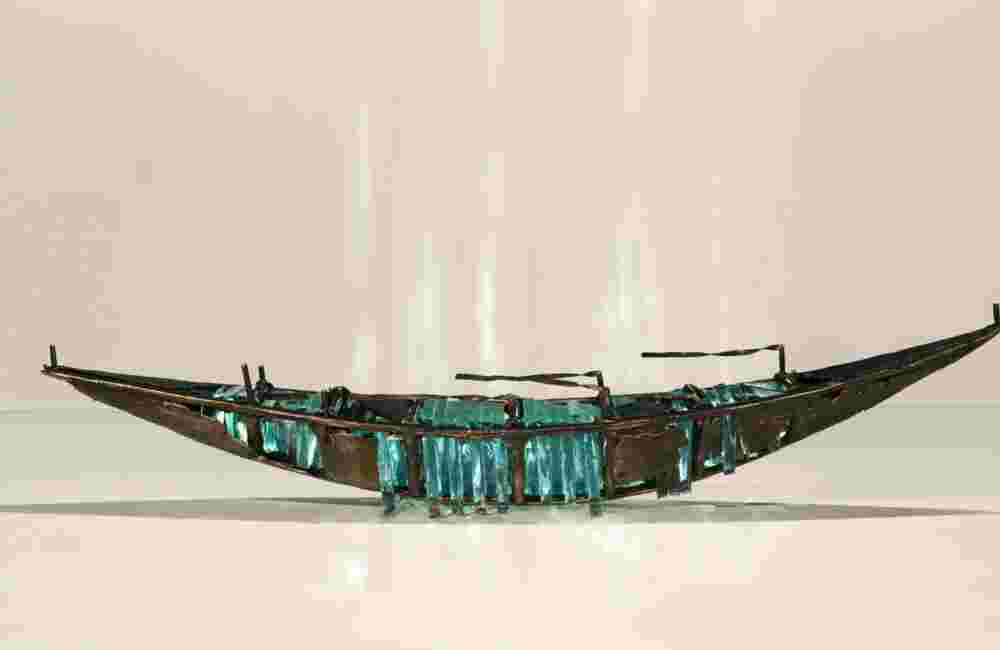 hipwreck boat sculpture made of hand cut glass and bronze.