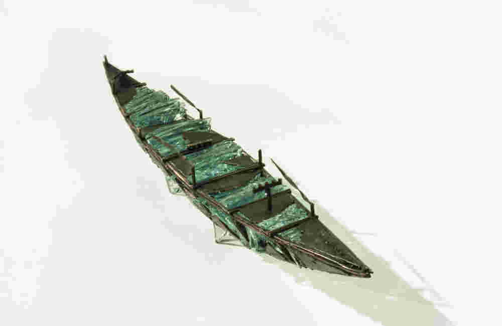 Shipwreck boat sculpture made of hand cut glass and bronze.