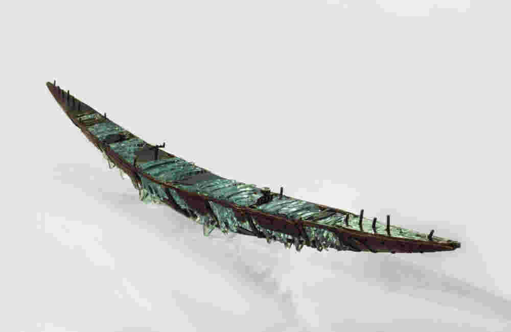 Shipwreck boat sculpture made of hand cut glass and bronze.