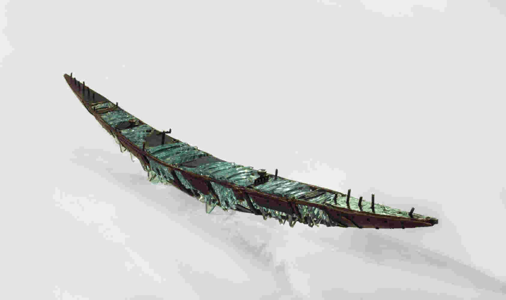 Shipwreck boat sculpture made of hand cut glass and bronze.