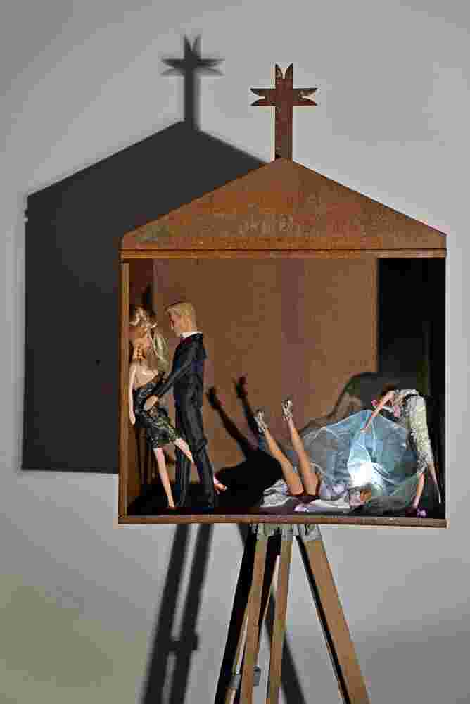 Mixed media art resembling small shrines made of rusted stee, barbies and toys. Related to the themes of vanity and religion.