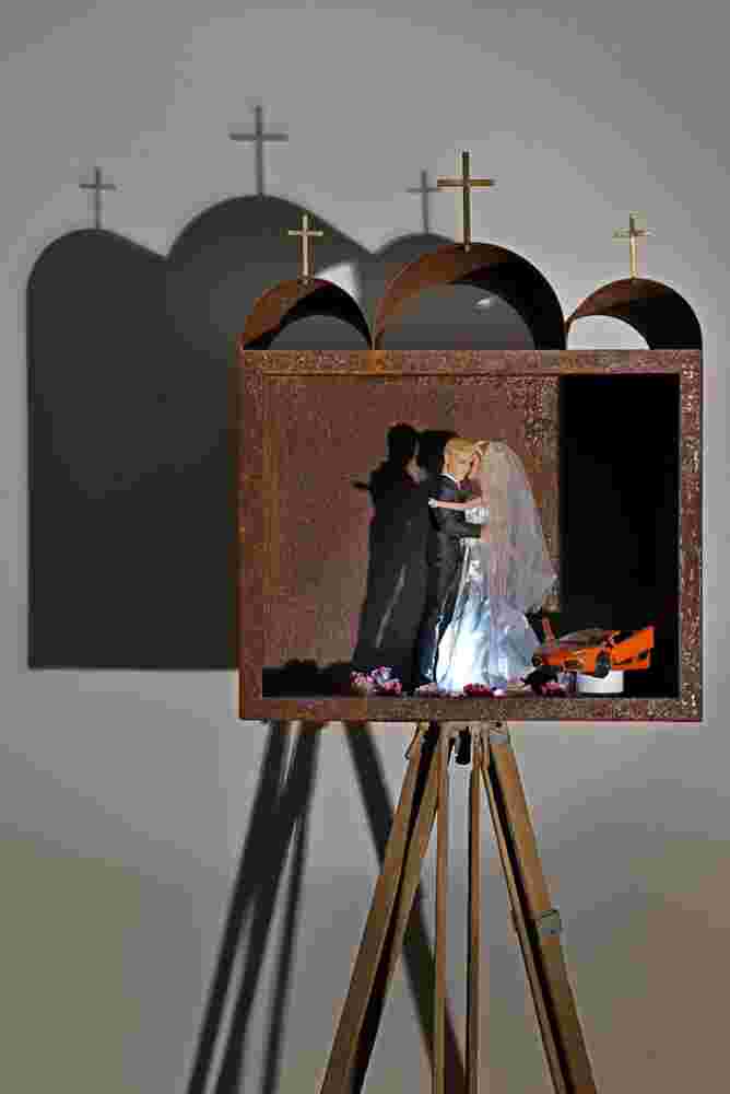 Mixed media art resembling small shrines made of rusted stee, barbies and toys. Related to the themes of vanity and religion.