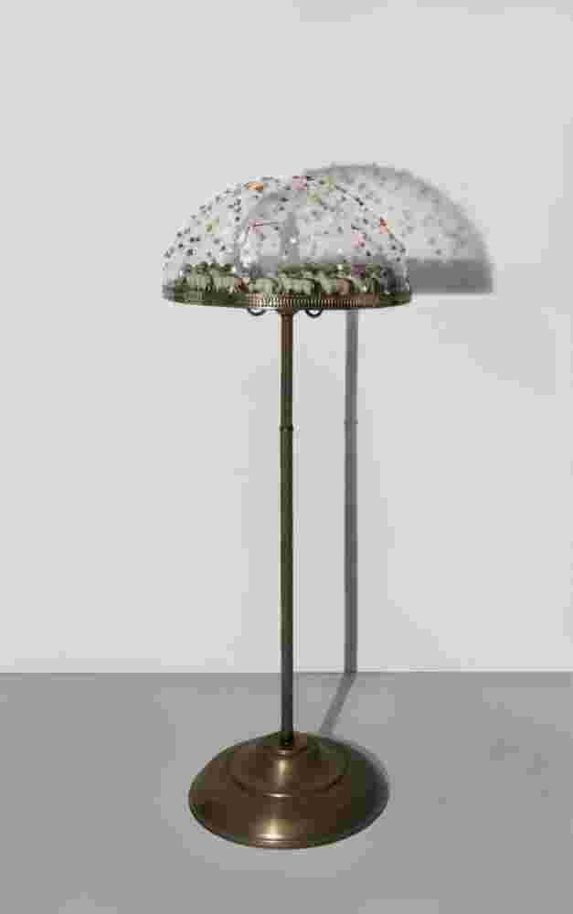 mixed media of a pope with a Pinocchio nose and sheep and colorful flowers made of plexiglass, bronze and found objects