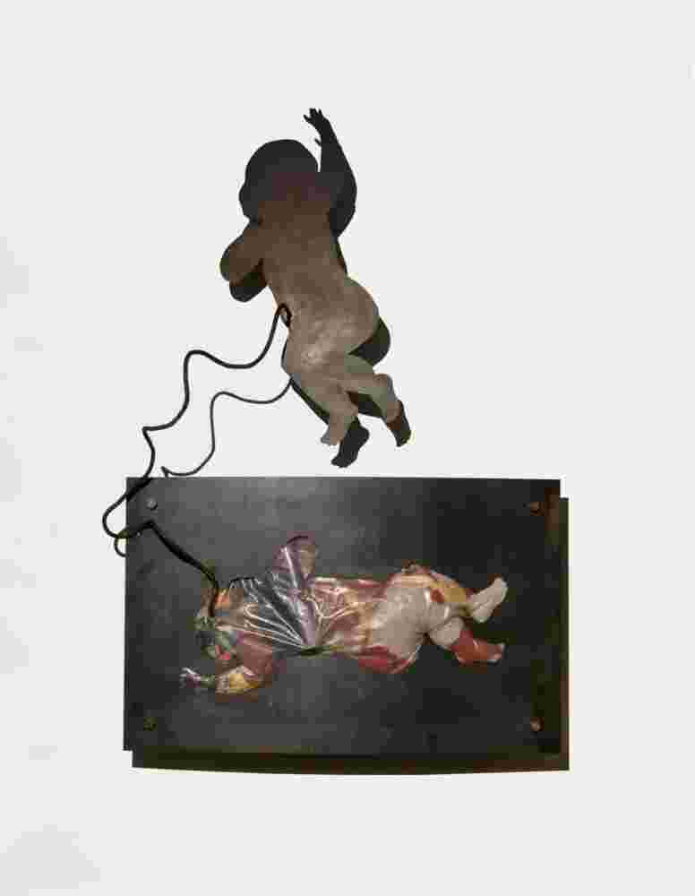 Iron and toys wall sculpture of a baby flying