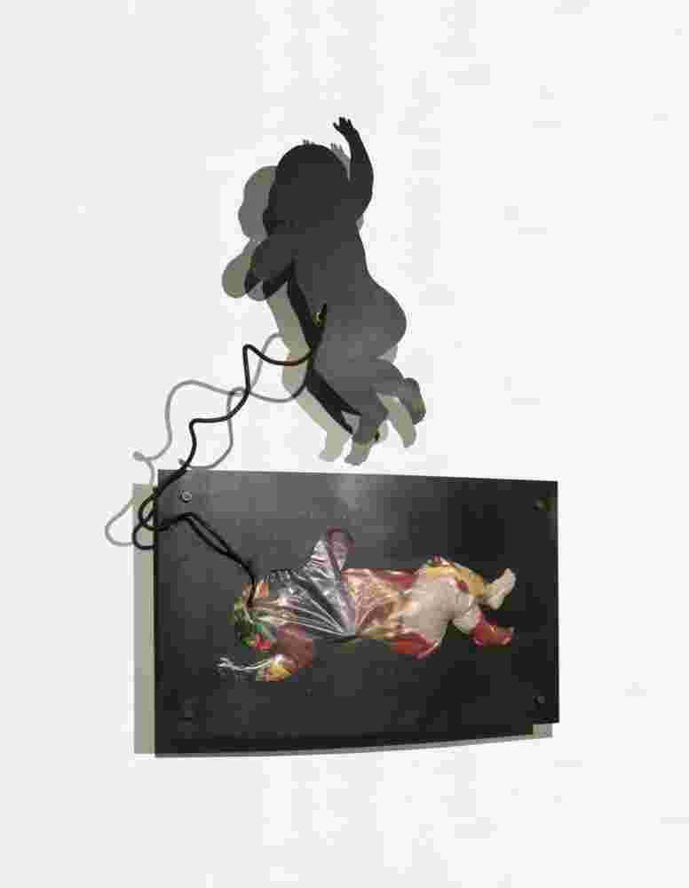 Iron and toys wall sculpture of a baby flying