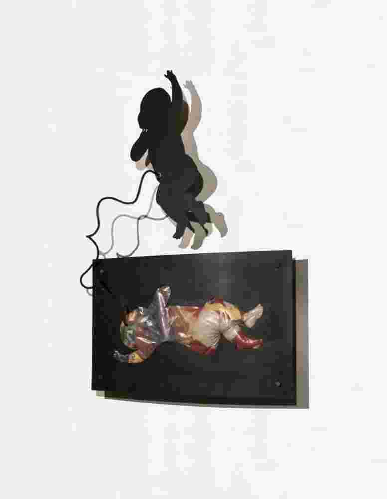 Iron and toys wall sculpture of a baby flying