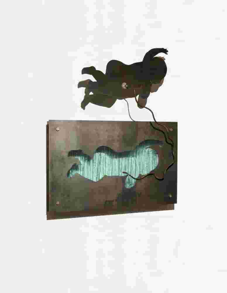Wall sculpture made of iron and glass of a baby flying