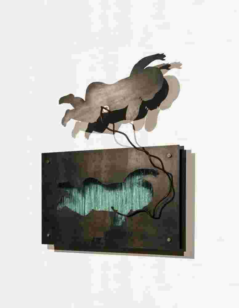 Wall sculpture made of iron and glass of a baby flying