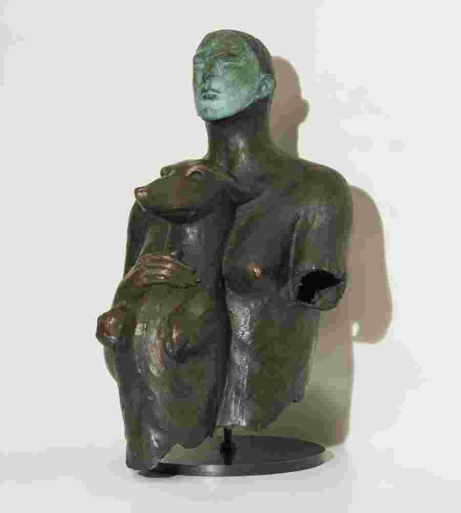 Bronze sculpture of a woman holding a dog