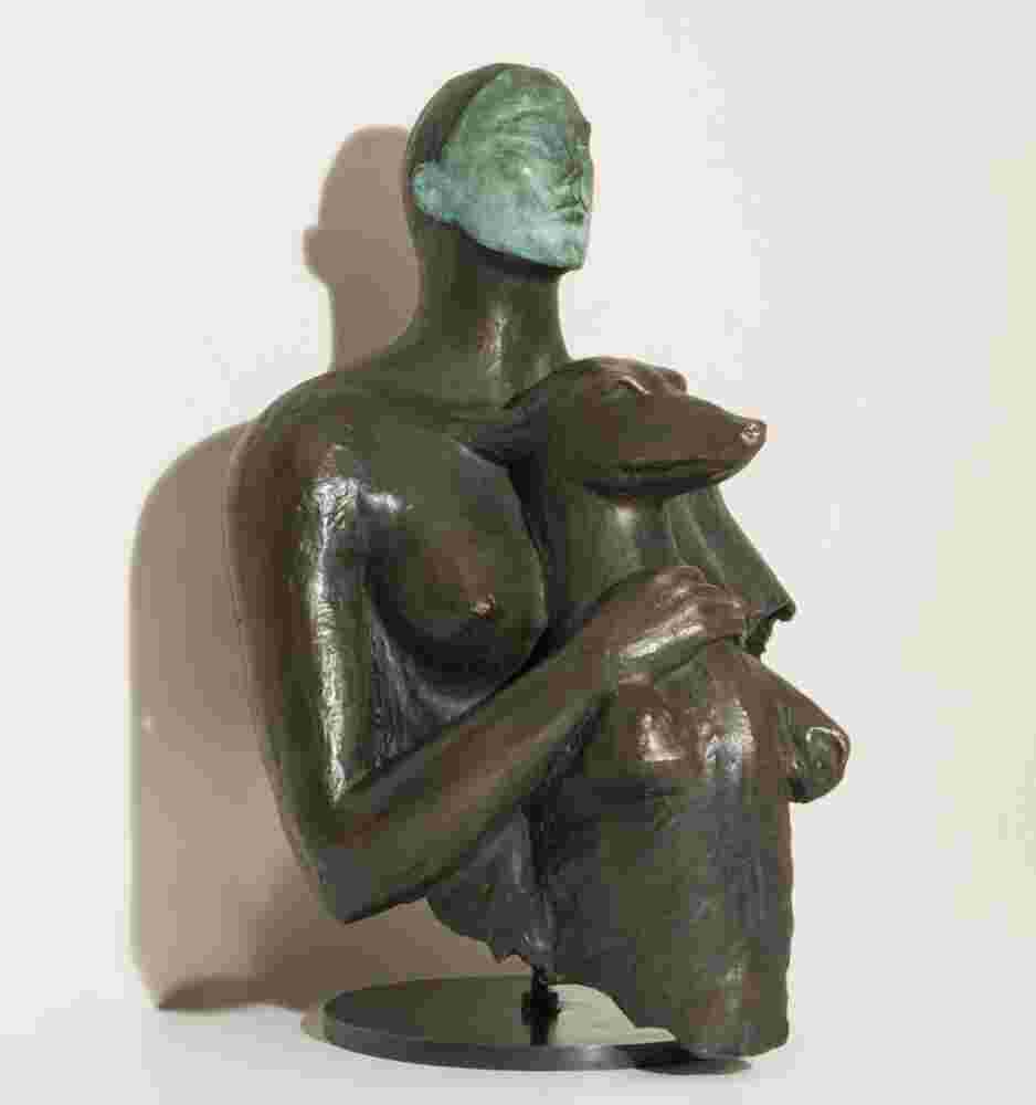 Bronze sculpture of a woman holding a dog